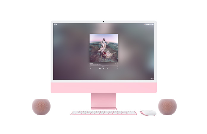 Parte frontal de un iMac rosado, Apple Music reproduciendo música en la pantalla, Magic Keyboard y Magic Mouse del mismo color, junto a dos parlantes HomePod mini 2 rosados formando un par estéreo