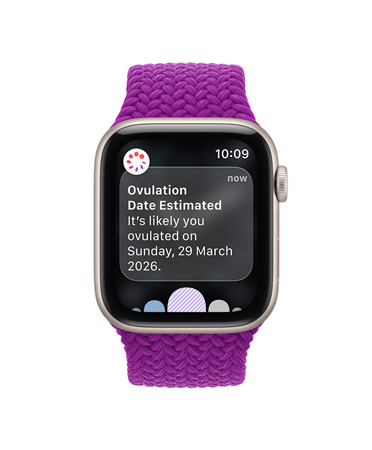 Apple Watch SE 3, screen shows estimated ovulation date, aluminum case, starlight color, Braided Solo Loop band, magenta color