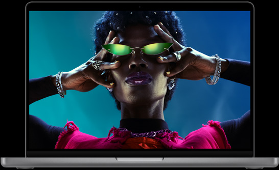 MacBook Pro, silver color, open, display shows image of person dressed in silver, crowd surfing