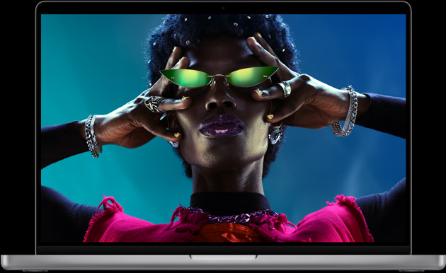 MacBook Pro, silver color, open, display shows image of person