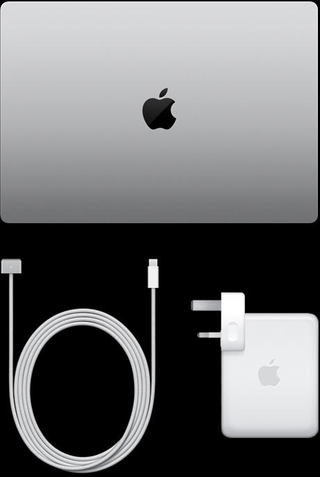 MacBook Pro, silver color, top, closed, next to charging cable and adapter