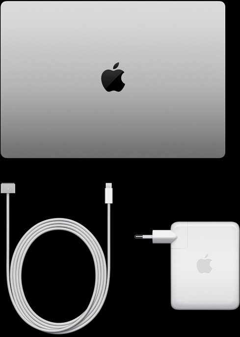 MacBook Pro, silver color, top, closed, next to charging cable and adapter