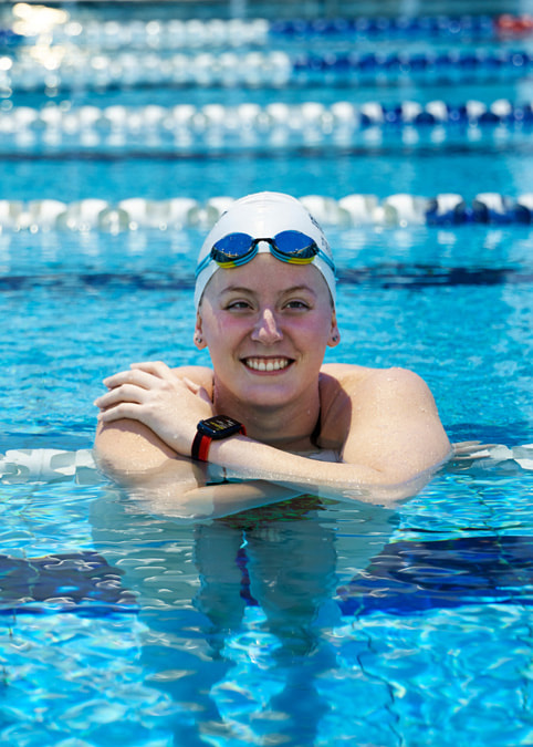 Katja Dedekind posing in the pool with her Apple Watch.