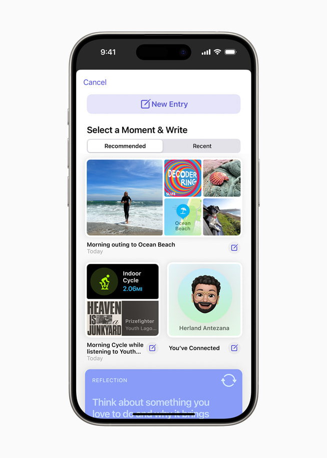 An iPhone 15 Pro shows the Journal app interface, prompting the user, “Select a Moment & Write.” 