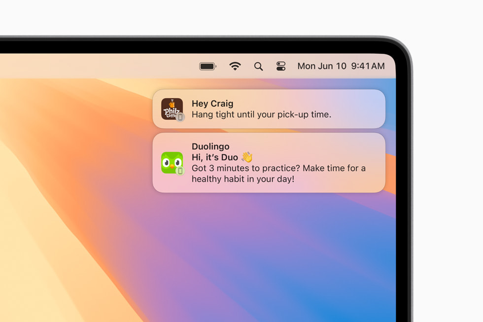 Notifications from a user’s iPhone show up in the corner of their MacBook Pro.