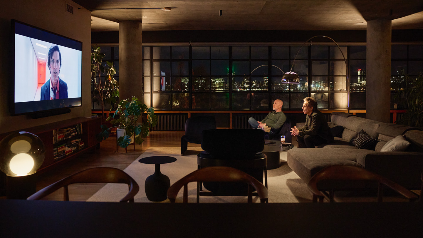 Geoffrey Richman and Ben Still watching the season two finale of “Severance” on a large television.