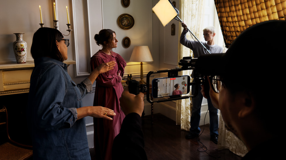 An image of a film production set, with an iPhone recording in horizontal orientation seen in the foreground.