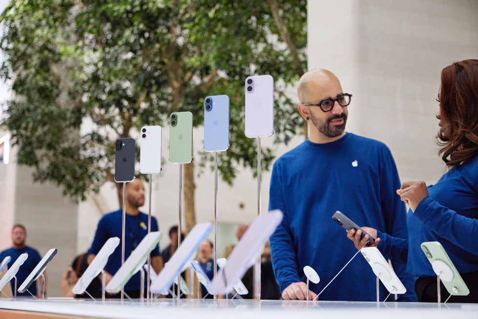 Apple Regent Street team members await customers at the iPhone 17 display table.