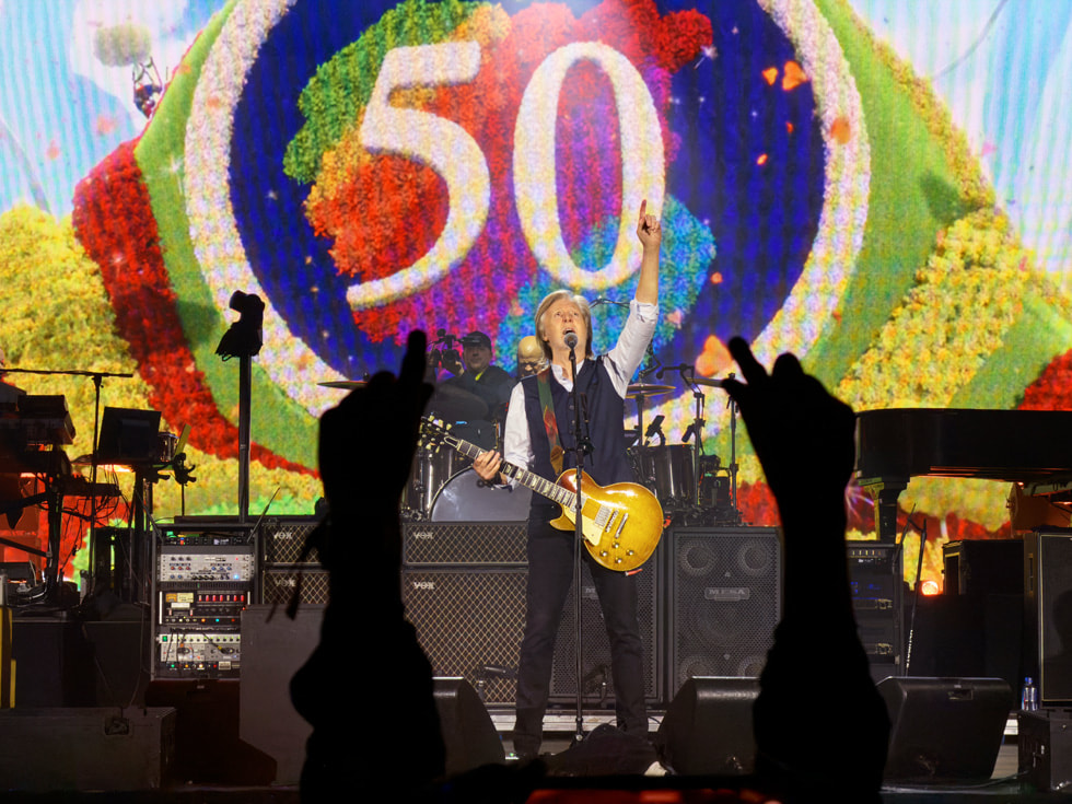 Paul McCartney is shown performing on stage at Apple Park in Cupertino. 