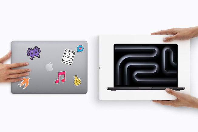 One hand holds a customer’s used MacBook, and two hands hold a new MacBook Pro in the box.