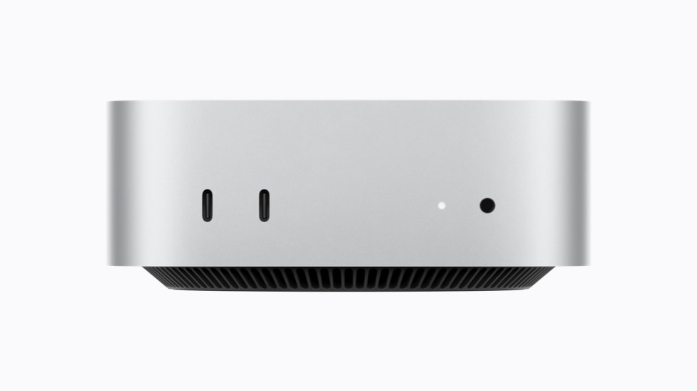 Mac mini vises forfra med dens to USB-C-porte, der understøtter USB 3, og et jackstik til hovedtelefoner.
