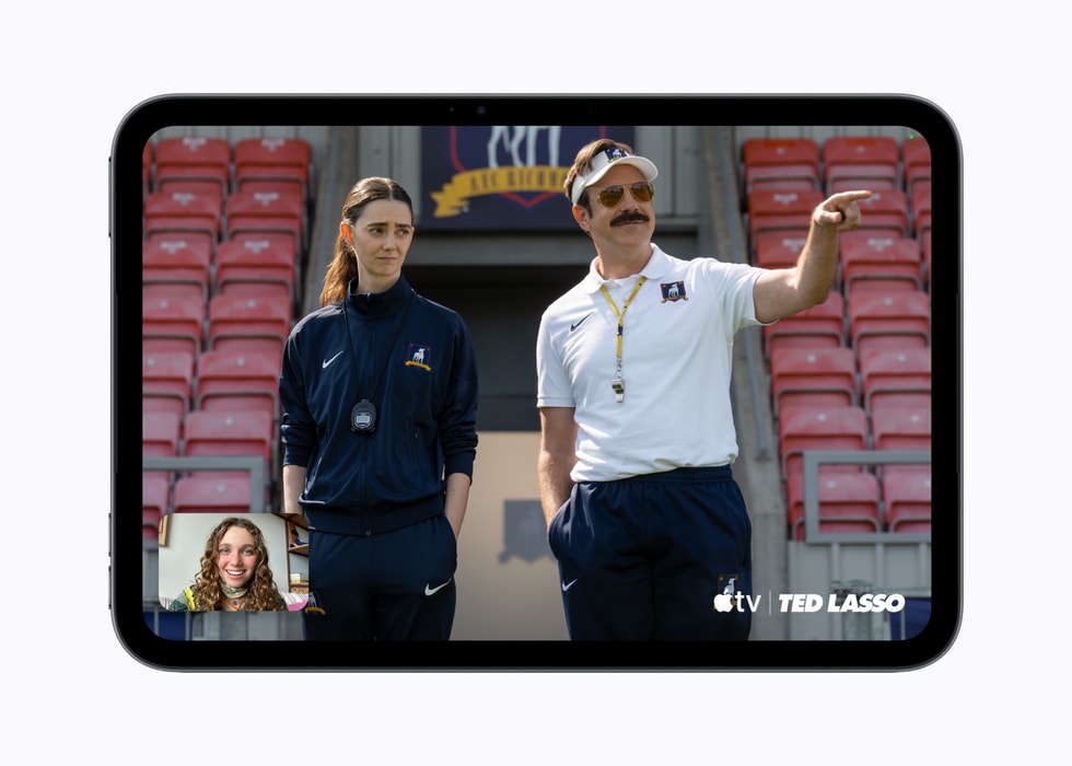 iPad mini shows a screen from the Apple TV Original “Ted Lasso” as well as a FaceTime call. 
