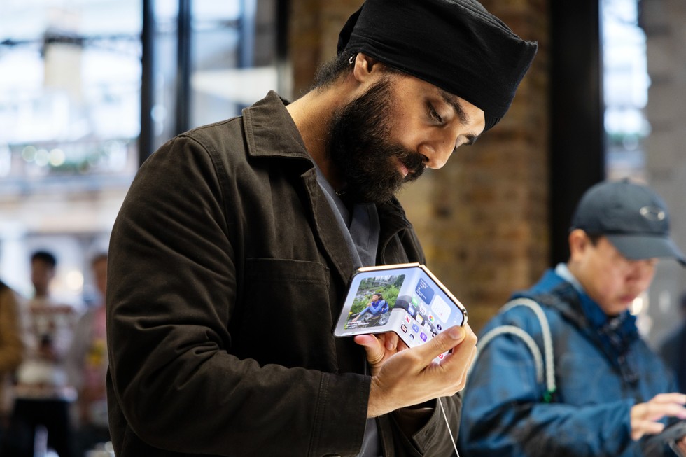 At Apple Covent Garden, a customer examines iPhone Duo up close.