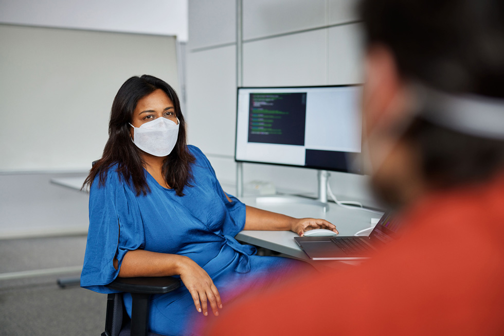 Tano Gupta with a coworker in a software engineering space in Munich.