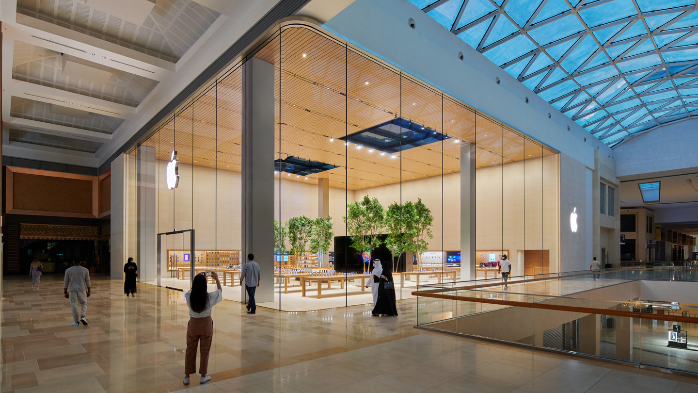 Outside Apple Yas Mall facing its curved glass exterior in Abu Dhabi.