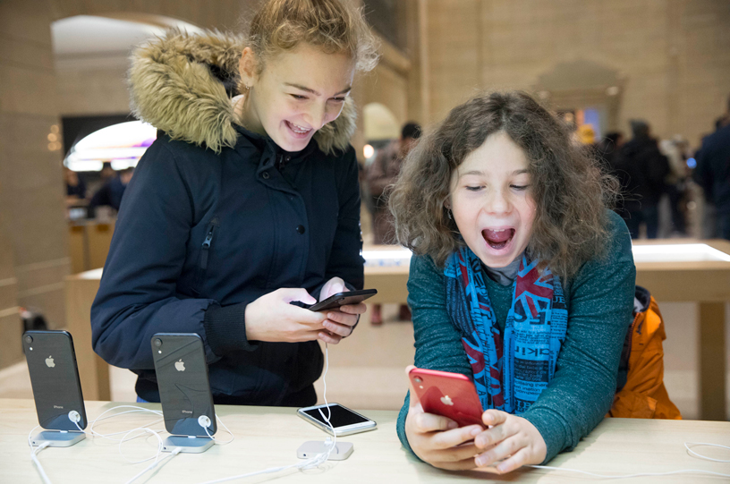 Children testing out the iPhone XR.