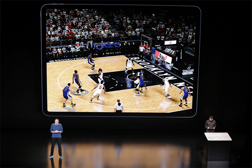 Greg Thomas demos NBA 2K19 on stage.