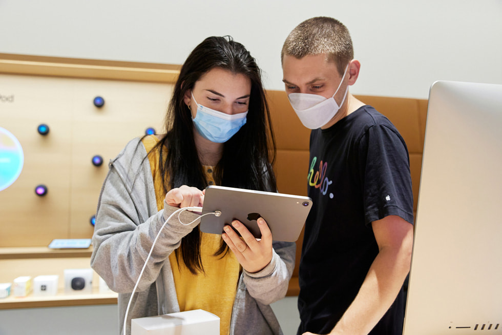 Two young customers checking out the new iPad mini inside Apple Bay Plaza.