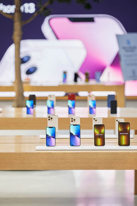 iPhone 13 models on display tables inside Apple Regent Street.