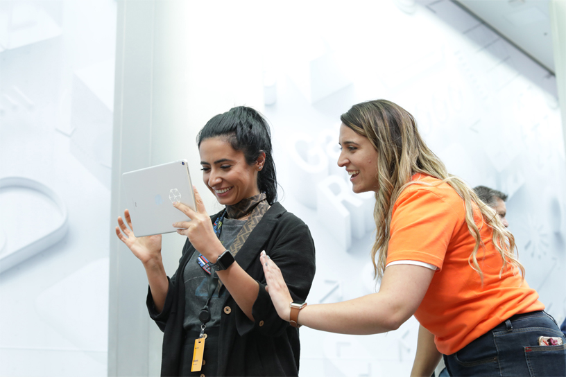 An Apple team member assists iPad AR user.