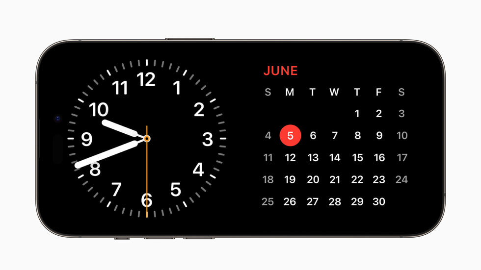 I iOS 17 på iPhone 14 Pro viser StandBy-funktionen et ur og en kalender.
