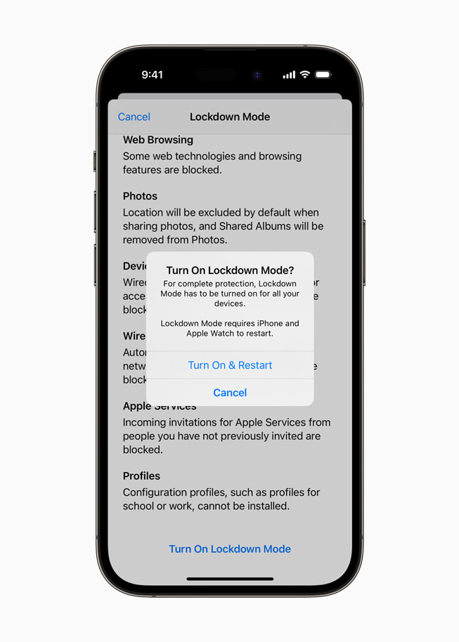 A prompt asking to turn on Lockdown Mode is shown on iPhone 14 Pro.
