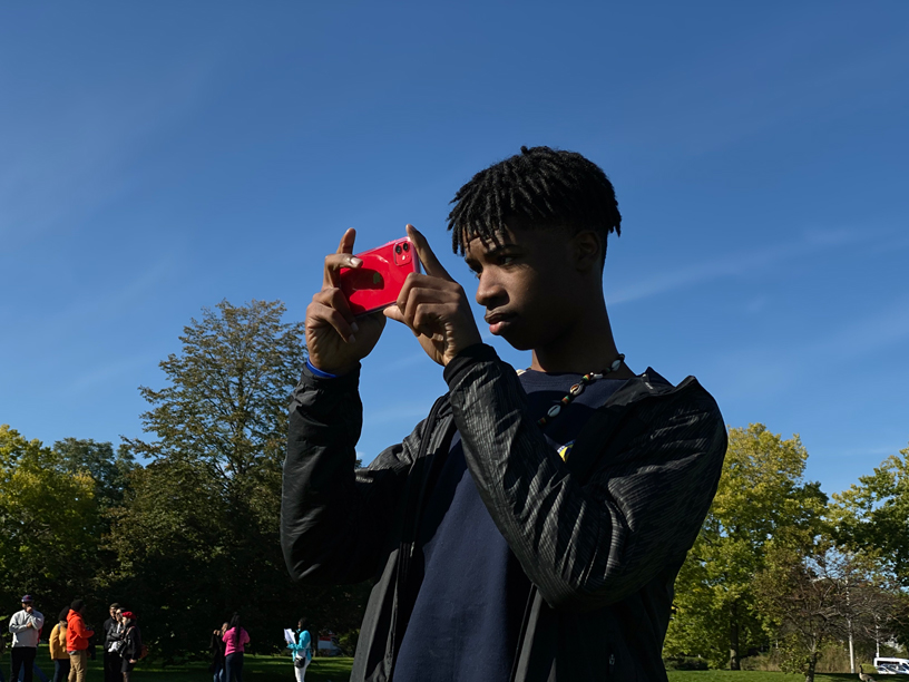 J takes a picture with iPhone 11.