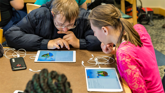Two students coding with Swift Playgrounds on iPads.