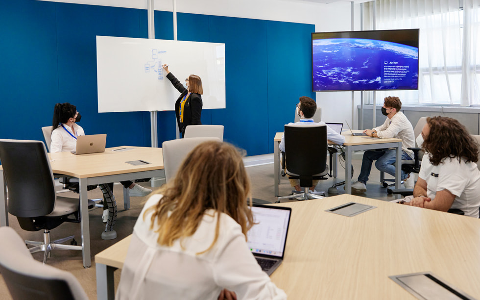 Students in a classroom at Naples Developer Academy learn from an instructor.
