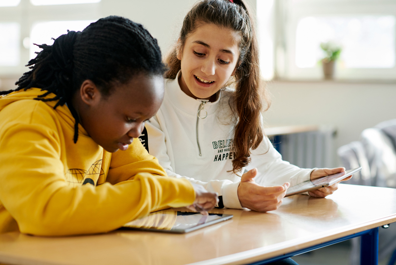 Students Sharleen Wambui (left) and Medina Ibrahim work together on their iPads. 