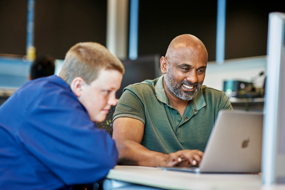 Daniel Parszuto and an instructor write code together on MacBook Air.