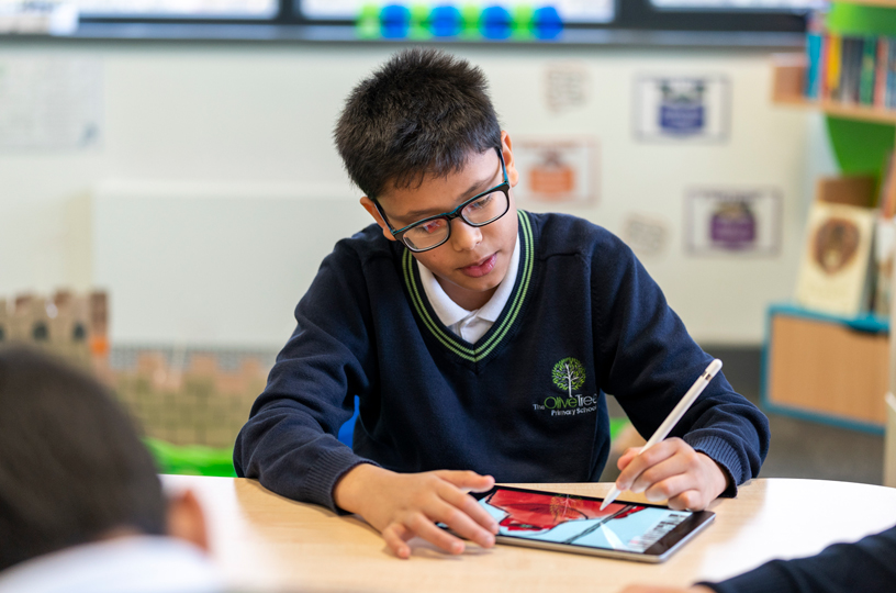 Student working on iPad with Apple Pencil.