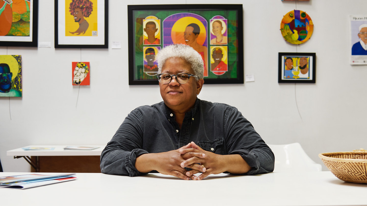 Artist Ajuan Mance sits at her workspace.