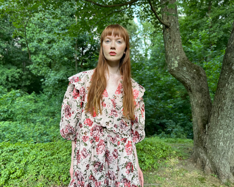 A model poses in an editorial image shot outdoors in Portrait mode.