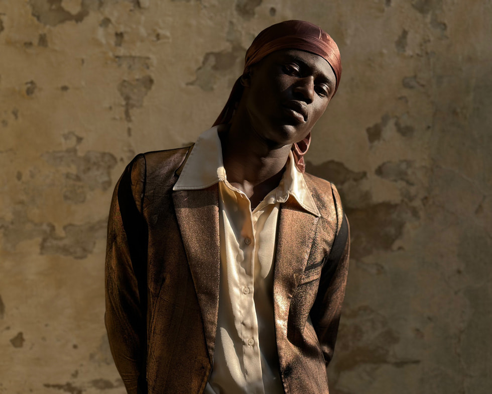 A model poses in an editorial image shot in Portrait mode.