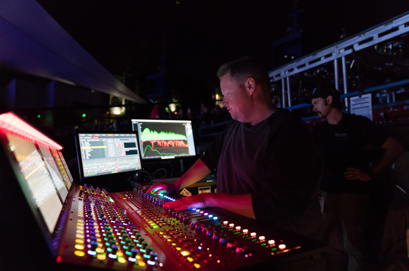 James “Pugsley” McDermott at a soundboard backstage.