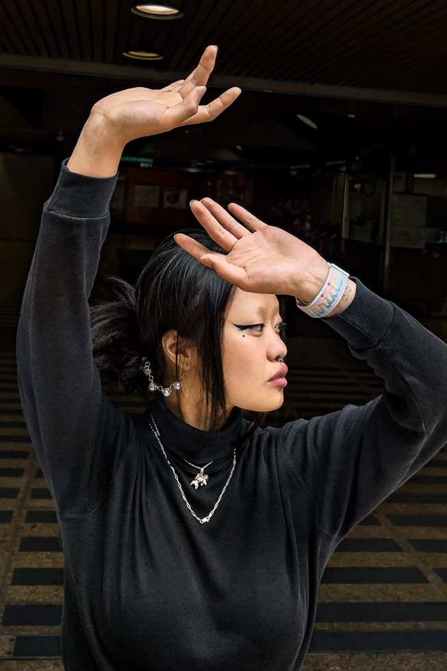 Jin Lee Baobei wearing the new Pride Edition Sport Loop band for Apple Watch.