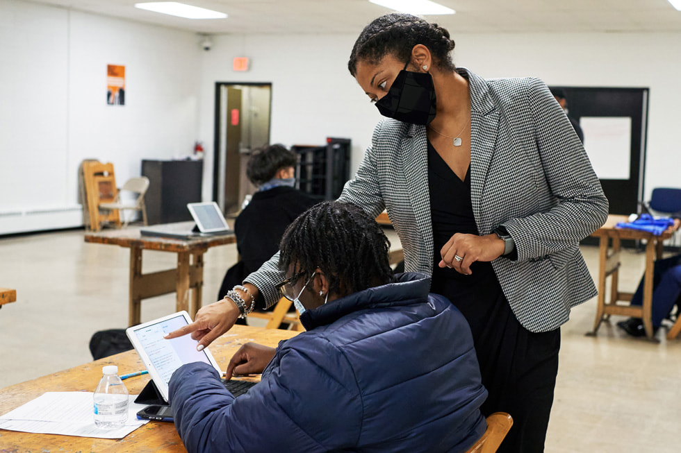 An instructor assists a student in a Boys & Girls Clubs of America classroom setting.