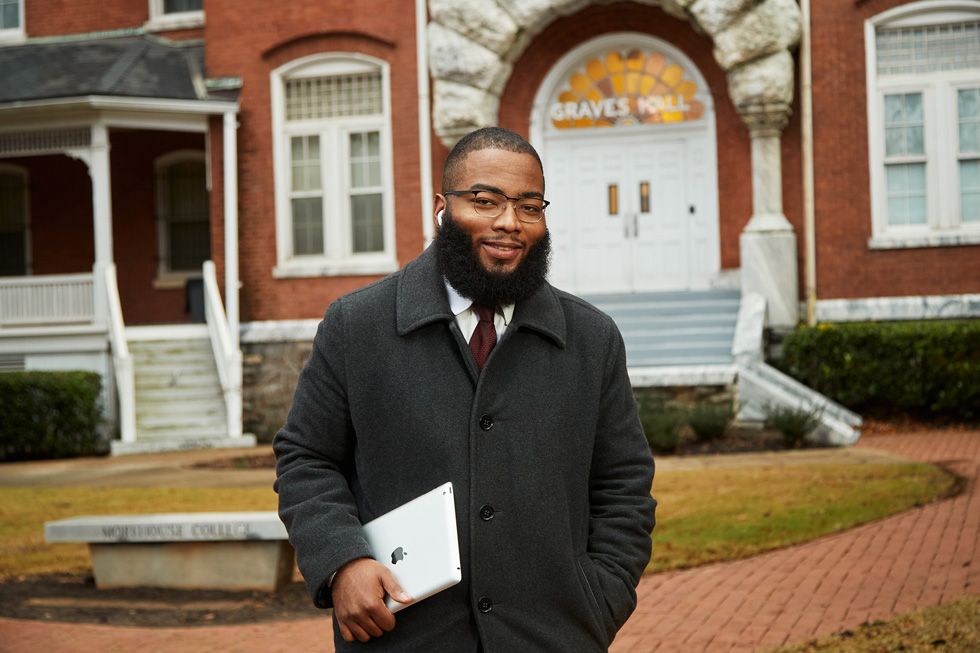 Jared Bailey wearing AirPods and holding an iPad.