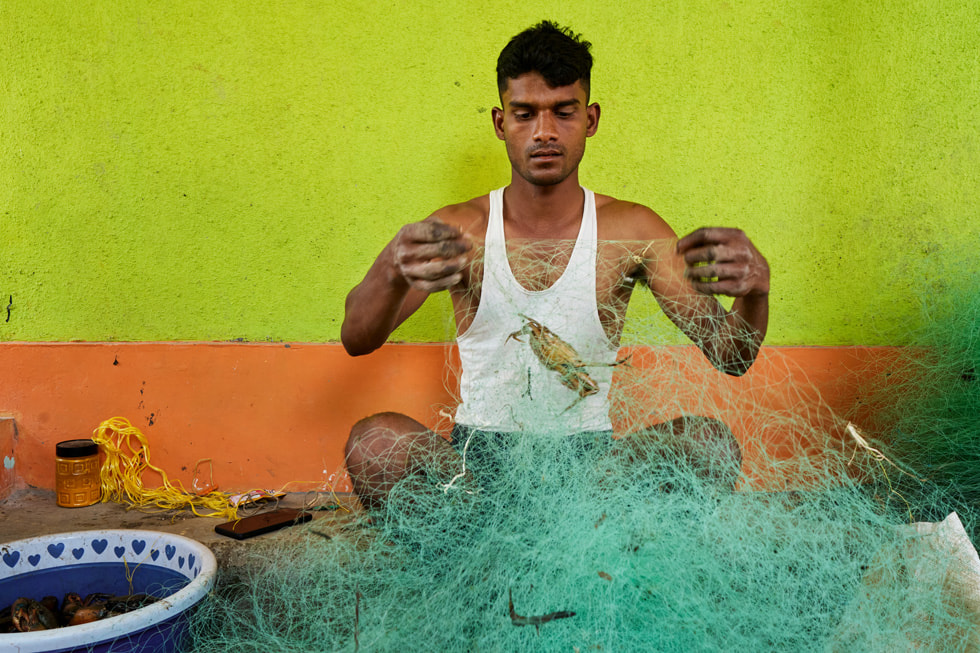 A fisherman examines his netting in India’s Raigad district.