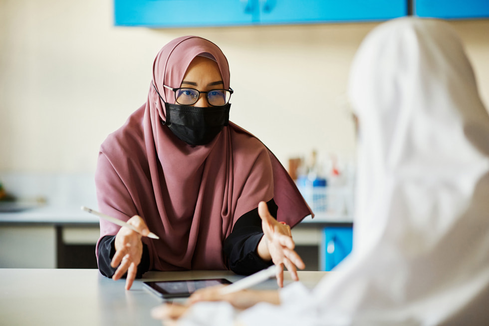 Shuhannah bte Sajali teaching a student at Madrasah Alsagoff Al-Arabiah.
