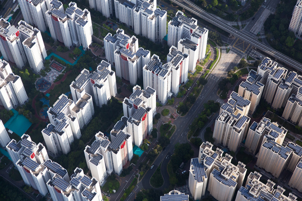 Buildings with rooftops outfitted with solar panels in Singapore.