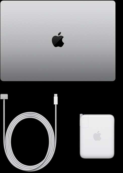 MacBook Pro, silver color, top, closed, next to charging cable and adapter