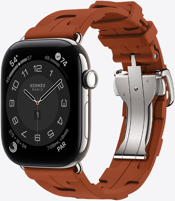 Apple Watch Hermès Series 12, den analoga urtavlan Circulaire, (timvisare, minutvisare och sekundvisare, komplikationer: väder, buller, aktivitetsringar och klockslag i Paris), titanboett i färgen silver, höger utsida, Digital Crown, sidoknapp, kombinerad med Kilim Simple Tour-armband i färgen Cuivre (brun), gjutet gummi, geometrisk sammanlänkad design, metallspänne i färgen silver