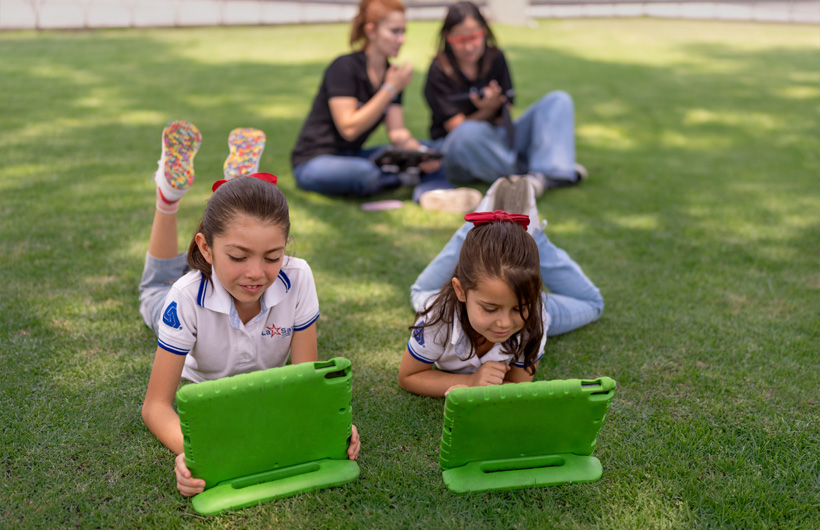 Ana Lilia Gómez Iniesta (ALC) supports teacher Eleane Ruth Guzmán Padilla while students work independently on a math lesson at Colegio Cristobal Colón.