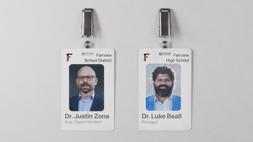 Zwei Dienstausweise von Lehrern des Fairview School District nebeneinander: der von Dr. Justin Zona links und der von Dr. Luke Beall rechts.