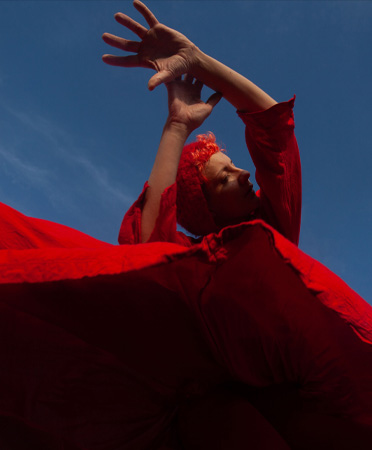 A person in a red dress dancing