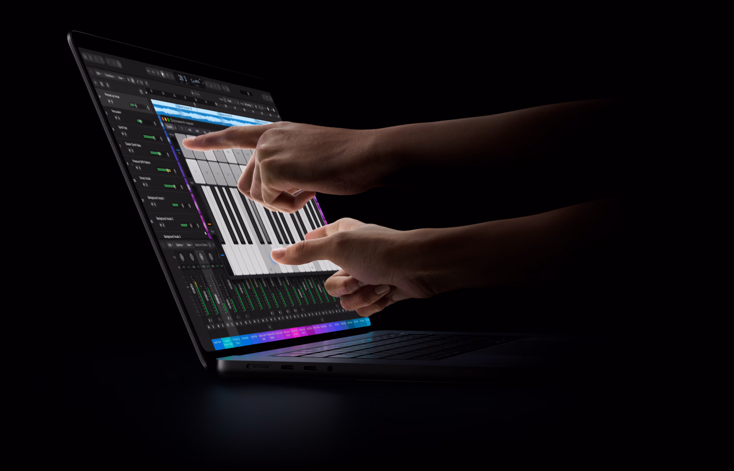 16-inch MacBook Pro with PROLED XDR Display, open lid, space black colour, display shows a Logic Pro workflow as hands reach over the keyboard to interact with the tools via Touch