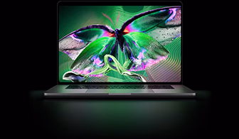 MacBook Pro with PROLED XDR Display, silver colour, display shows detailed, high-contrast image with vivid colours, screen illuminates keyboard