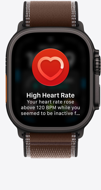 Apple Watch Ultra 4, das Display zeigt die Herzfrequenz App, aktuelle Schläge pro Minute, Titangehäuse, Farbe Schwarz, verbunden mit Trail Loop Armband in Dunkelumbra (braun)